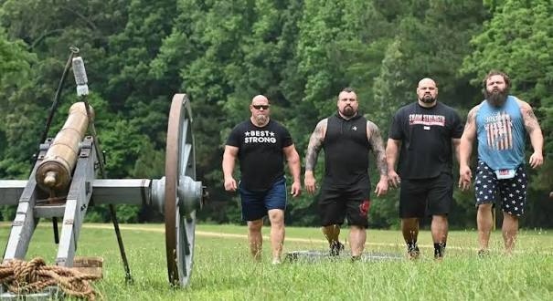 Nick Best in a Best Strong tee with the cast preparing to pull a cannon
