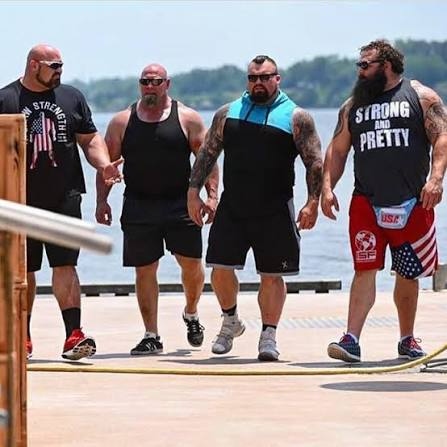 The Strongest Man in History cast on a lakeside dock